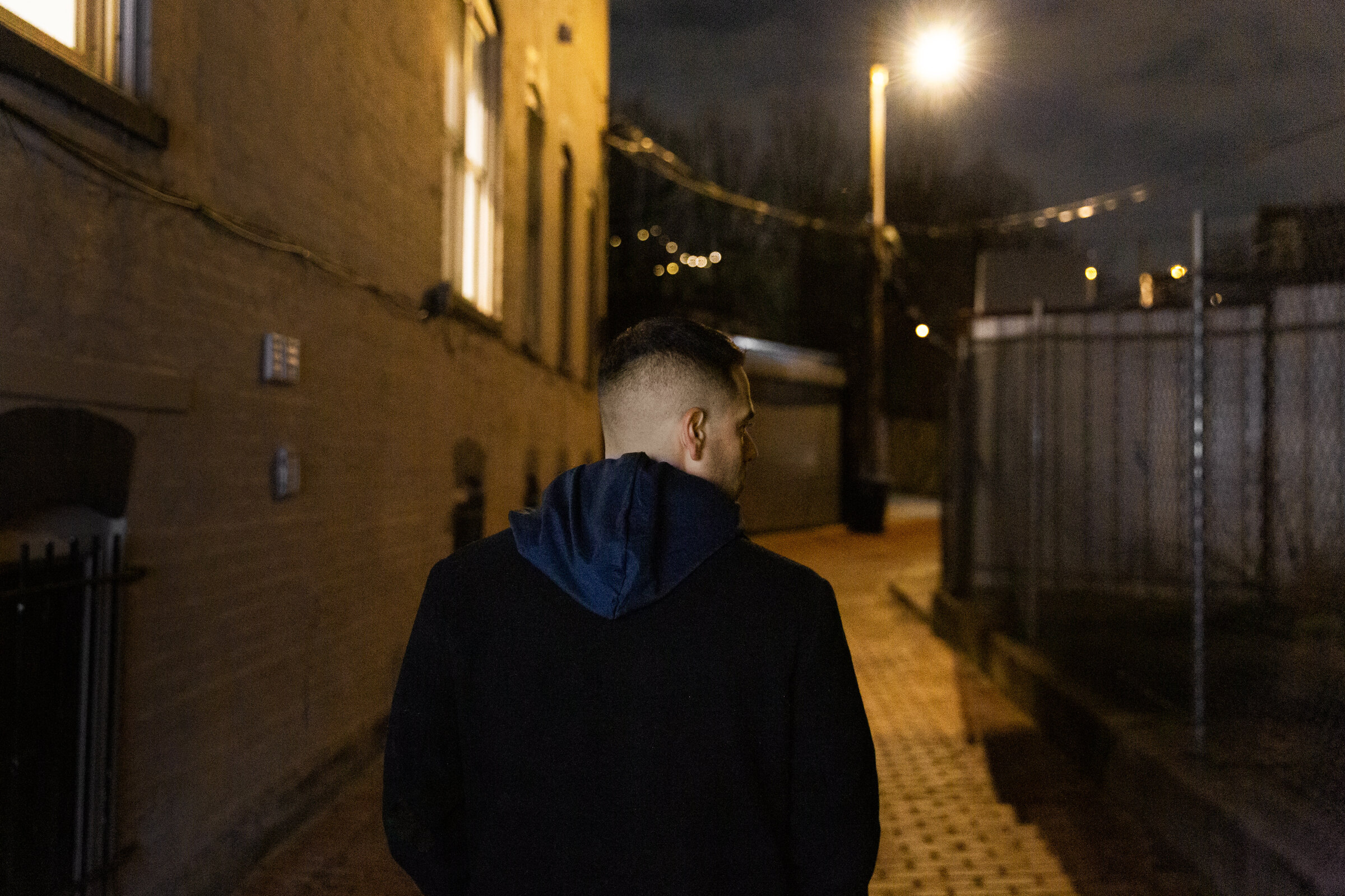 Andrew Weiss walking in alley